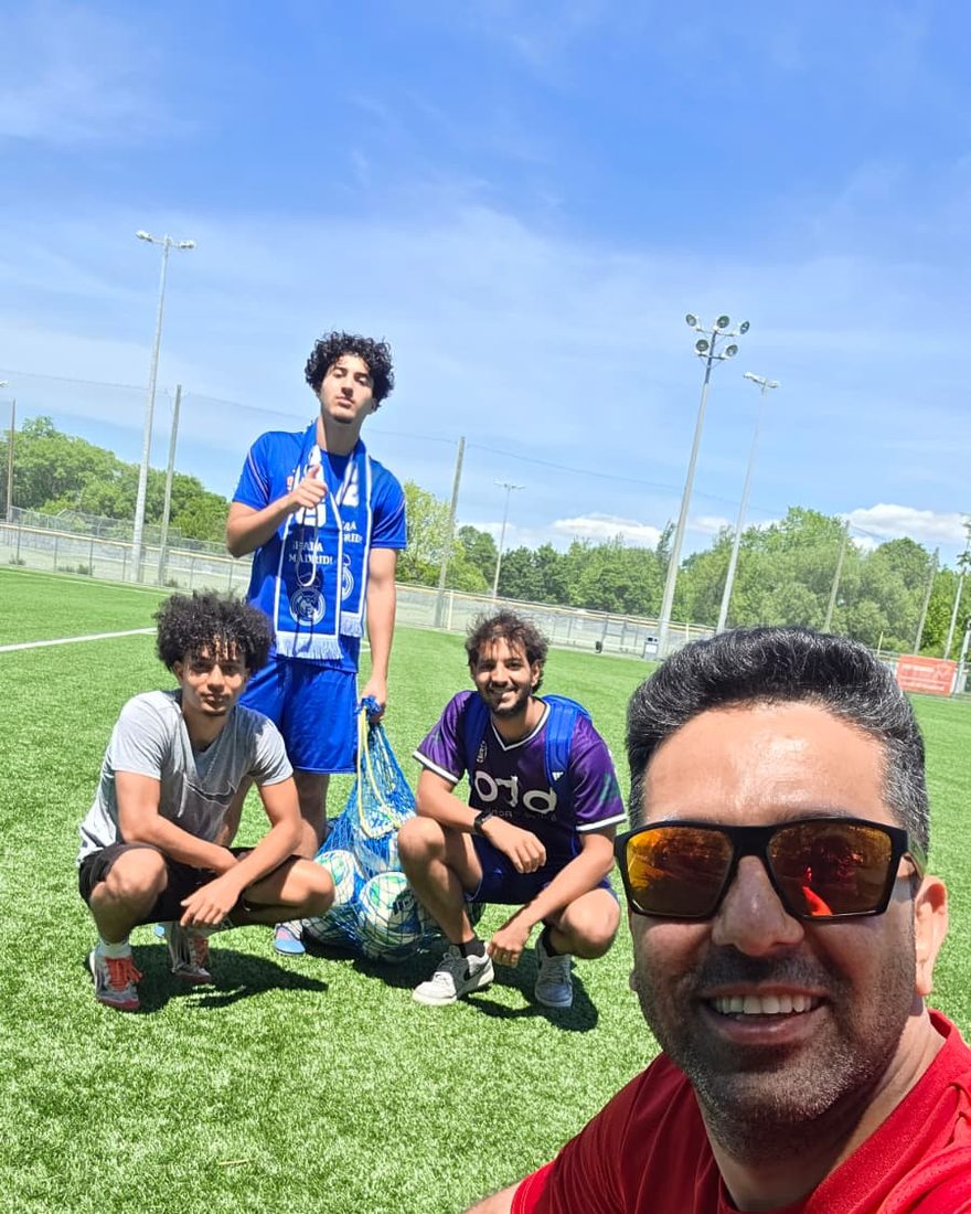 Coach Reza with players after a summer session