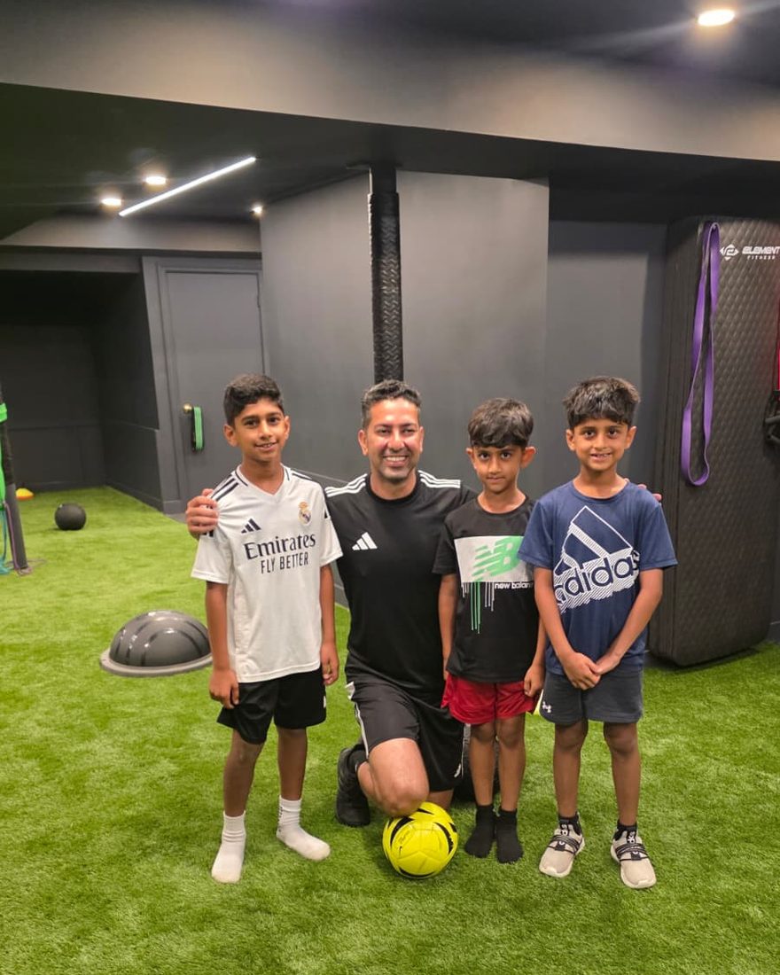Coach Reza with young players at an indoor session